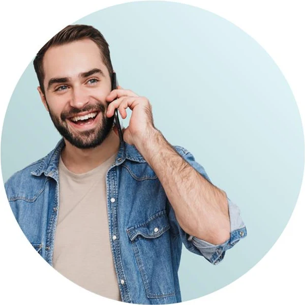 A smiling man on a phone call